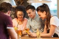 Happy friends with smartphones and drinks at bar Royalty Free Stock Photo