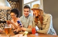 Happy friends with smartphones and drinks at bar Royalty Free Stock Photo