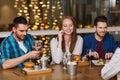 Happy friends with smartphones at restaurant Royalty Free Stock Photo