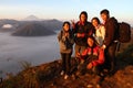 Happy friends smiling at the top of a mountain