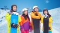 Happy friends with snowboards over mountains Royalty Free Stock Photo