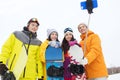 Happy friends with snowboards and smartphone