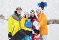 Happy friends with snowboards and smartphone