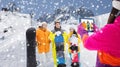 Happy friends with snowboards and tablet pc