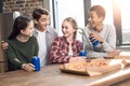 Happy friends spending time together with pizza and soda drinks Royalty Free Stock Photo