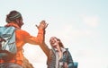 Happy friends stacking hands while doing trekking excursion on mountain - Young tourists walking and exploring the wild nature Royalty Free Stock Photo