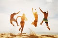 Happy friends sunset beach run jump Royalty Free Stock Photo