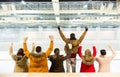 Happy friends supporting team on ice rink arena Royalty Free Stock Photo