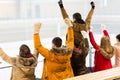 Happy friends supporting team on ice rink arena Royalty Free Stock Photo