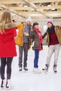 Happy friends taking photo on skating rink Royalty Free Stock Photo