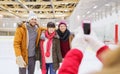 Happy friends taking photo on skating rink Royalty Free Stock Photo