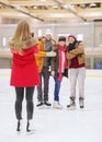 Happy friends taking photo on skating rink Royalty Free Stock Photo