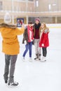 Happy friends taking photo on skating rink Royalty Free Stock Photo