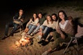 Happy friends taking selfie at camp fire on beach Royalty Free Stock Photo