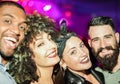 Happy friends taking selfie  in night club dance floor - Young people enjoying weekend nightlife and having fun together - Soft Royalty Free Stock Photo