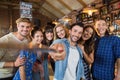Happy friends taking selfie in pub Royalty Free Stock Photo