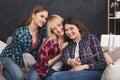 Happy friends taking selfie with smartphone and monopod Royalty Free Stock Photo
