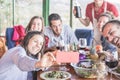 Happy friends taking selfie during vegetarian dinner at home - Group of young people having fun with trends technologies - Focus Royalty Free Stock Photo