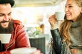 Happy friends toasting coffee and cappuccino at bar restaurant cafÃÂ¨ - Young hipster people enjoying breakfast drinking hot Royalty Free Stock Photo