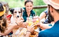 Happy friends toasting healthy orange fruit juice at countryside picnic - Friendship concept with alternative people having fun Royalty Free Stock Photo