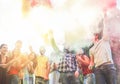 Happy friends using smoke bombs colors at party festival outdoor - Young students having fun and celebrating together - Youth and Royalty Free Stock Photo