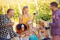 Happy friends in vineyard tasting wine - Young multiracial people enjoying time together outside at countryside Royalty Free Stock Photo