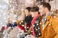 Happy friends watching hockey game on skating rink Royalty Free Stock Photo