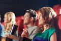 Happy friends watching movie in theater Royalty Free Stock Photo