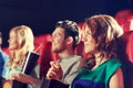 Happy friends watching movie in theater Royalty Free Stock Photo