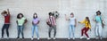 Happy friends wearing face mask listening music with vintage boombox outdoor - Multiracial young people having fun dancing Royalty Free Stock Photo