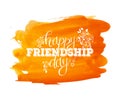 Happy Friendship day, holiday of the best friends. Hand drawn congratulatory inscription on orange abstract watercolor