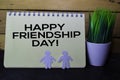 Happy Frindship Day! write on Book isolated on wooden table Royalty Free Stock Photo