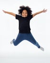 Happy and fun African American black kid jumping with hands raised isolated over white background. Royalty Free Stock Photo