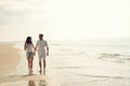 Happy fun beach vacations couple walking together laughing having fun on travel destination. Royalty Free Stock Photo