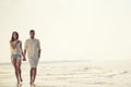 Happy fun beach vacations couple walking together laughing having fun on travel destination. Royalty Free Stock Photo