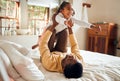 Happy, fun and dad with child on bed playing, bonding and airplane game for father and daughter time in home. Family Royalty Free Stock Photo