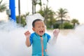 Happy and fun of little asian baby boy in swimming suit having fun in foam party at the pool outdoor Royalty Free Stock Photo