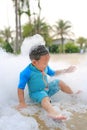 Happy and fun of little asian baby boy in swimming suit having fun in foam party at the pool outdoor Royalty Free Stock Photo