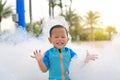 Happy and fun of little asian baby boy in swimming suit having fun in foam party at the pool outdoor Royalty Free Stock Photo