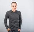 Happy fun young man laughing with wide opened mouth in casual clothing on blue background Royalty Free Stock Photo