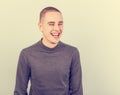 Happy fun young man laughing with wide opened mouth in casual clothing on blue background Royalty Free Stock Photo