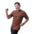 Happy Funny Asian Man Wearing Indonesian Batik Dancing Full of Joy Royalty Free Stock Photo