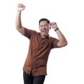 Happy Funny Asian Man Wearing Indonesian Batik Dancing Full of Joy Royalty Free Stock Photo