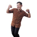 Happy Funny Asian Man Wearing Indonesian Batik Dancing Full of Joy Royalty Free Stock Photo