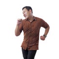 Happy Funny Asian Man Wearing Indonesian Batik Dancing Full of Joy Royalty Free Stock Photo