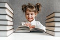 Happy funny baby girl in glasses reading a book. Emotional girl. To school soon Royalty Free Stock Photo