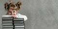 Happy funny baby girl in glasses reading a book. Emotional girl. To school soon. Copy space. Royalty Free Stock Photo