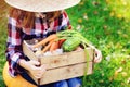 Happy funny child girl in farmer hat and shirt playing and picking autumn vegetable harvest Royalty Free Stock Photo