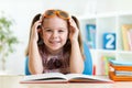 Happy funny child girl in glasses reading a book Royalty Free Stock Photo