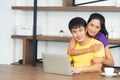 Happy and funny family. Asian lovely couple, beautiful woman and handsome man is having breakfast, talking in the kitchen